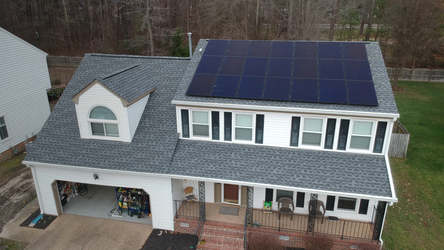 top view of a house with shingle roof and solar panels